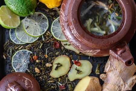 teapot with ingredients for tea beverage recipe with lime and ginger helpful for colds.の写真素材