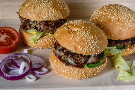 Three fresh burger lay on the board. Homemade fast food more tasty and healthy.の写真素材