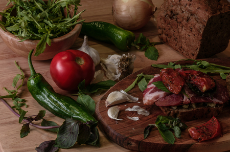 sandwich with pesto, sun-dried tomatoes, basil, arugula and smoked beef. Homemade fastfoodの写真素材