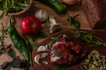 sandwich with rye bread, pesto, sun-dried tomatoes, basil, arugula and beef. View from aboweの写真素材
