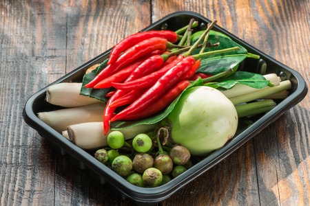 Tom kha ingredients set for Thai cooking in black plactic pallet on wooden tableの写真素材