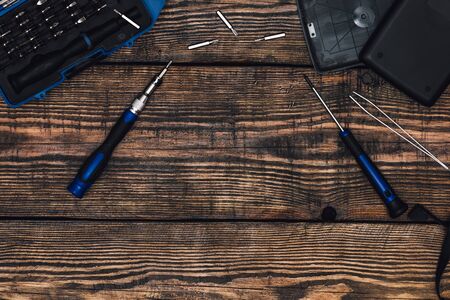 Precision Screwdriver and Some Tools on Wooden Table with Place for Textの写真素材