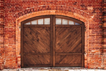 Old Brick Wall with Arch and Wooden Door.の写真素材