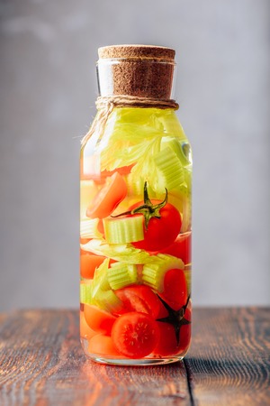 Bottle of Detox Water with Cherry Tomato and Celery Stems. Vertical Orientation.の写真素材
