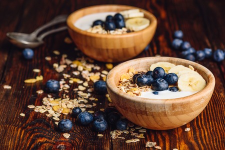 Healthy Breakfast with Granola, Banana, Blueberry and Greek Yoghurt. Scattered Ingredients on Wooden Table.の写真素材