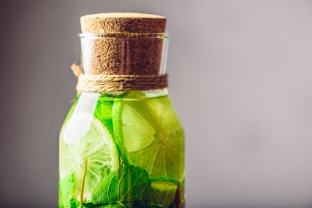 Part of Bottle of Flavored Water with Lime, Mint and Blueberry. Copy Space on the Right.の写真素材