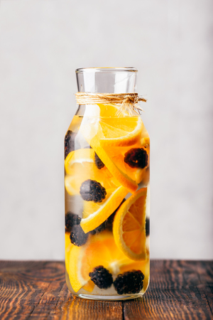Bottle of Infused Water with Sliced Raw Orange and Fresh Blackberry.の写真素材