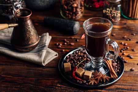Cezve and Glass of Coffee with Beans, Refined Sugar and Oriental Spices.の写真素材