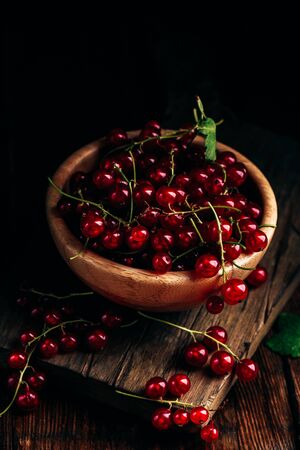 Fresh picked red currants in wooden bowlの写真素材