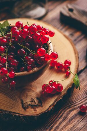 Fresh picked red currants in wooden bowlの写真素材