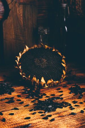 Dried sunflower and roasted seeds on the old wooden tableの写真素材