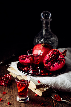 Shots of pomegranate cocktail with vodka and juiceの写真素材