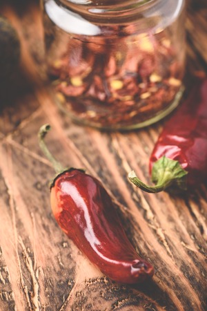 Sun dried red chili peppers on wooden surfaceの写真素材