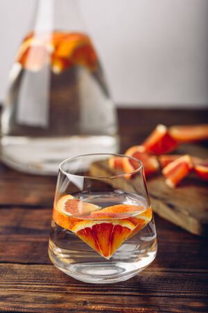 Water infused with red oranges in glassの写真素材