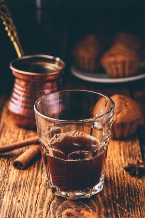 Turkish coffee with spices and oatmeal muffins on wooden surfaceの写真素材