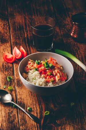 Scrambled eggs with tomatoes, leek and white rice. Turkish coffee and sliced ingredients.の写真素材