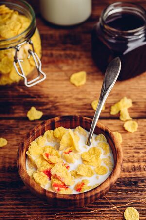 Breakfast with corn flakes, milk and berry syrupの写真素材