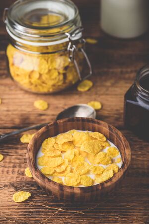 Breakfast with corn flakes, milk and berry jamの写真素材