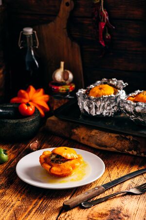 Pattypan squash filled with ground meat, leek, carrot, garlic and spicesの写真素材