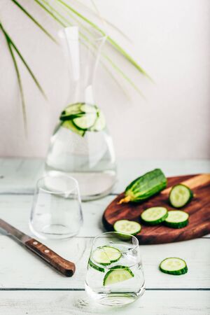 Water infused with sliced cucumber in a drinking glassの写真素材
