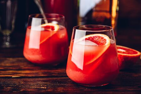 Whiskey sour cocktail with aged bourbon, blood orange juice and cherry syrupの写真素材