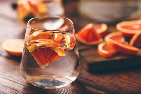 Infused water with bloody oranges in drinking glassの写真素材