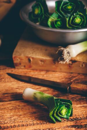 Prepare of fresh green leek on wooden tableの写真素材