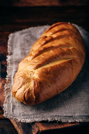 A loaf of bread on a wooden tableの写真素材