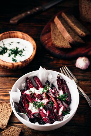 Oven baked beet fries with yogurt and dill dressingの写真素材