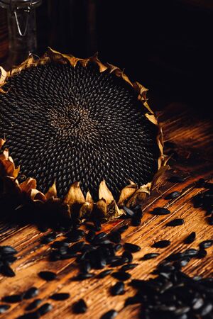 Dried sunflower and roasted seeds on the old wooden tableの写真素材
