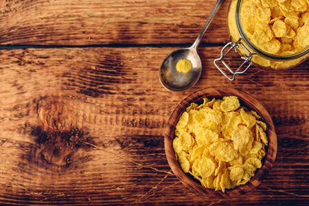 Corn flakes in a wooden bowl for breakfast. View from aboveの写真素材