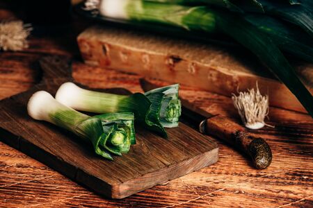 Fresh green leek on wooden cutting boardの写真素材