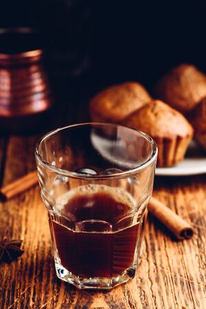Turkish coffee with spices and oatmeal muffins on wooden surfaceの写真素材