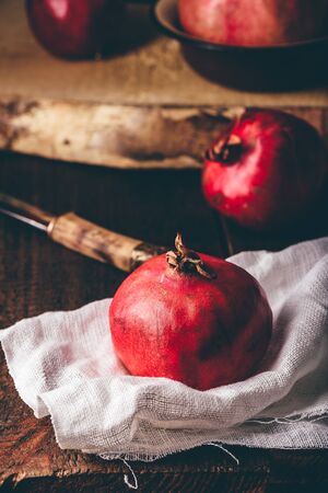 Red and ripe pomegranate fruits in rustic settingの写真素材