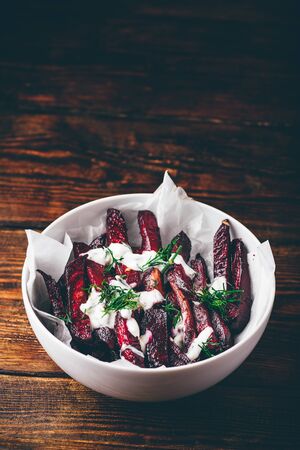 Oven baked beet fries with sour cream and dill dressingの写真素材