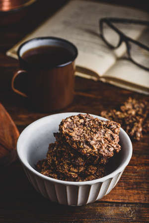 Banana oatmeal cookies with chocolate spread and mug of coffeeの写真素材