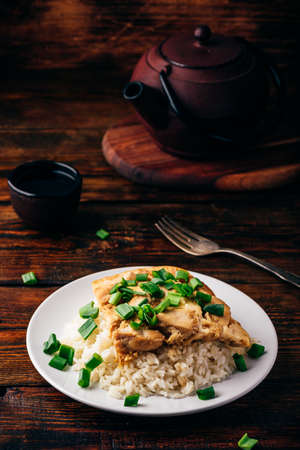 Oyakodon dish on white plate in rustic settingの写真素材