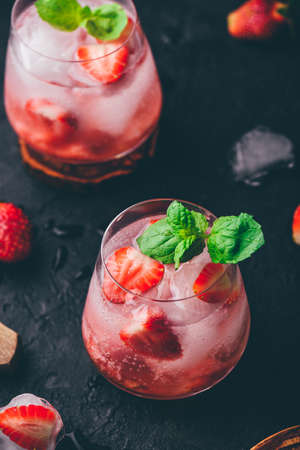 Cocktail with fresh and frozen strawberries, vodka and soda in glasses