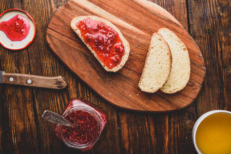 Toast with homemade raspberry jam with cup of green tea