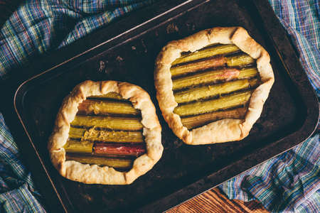 Rhubarb mini galettes on baking sheet. View from aboveの写真素材