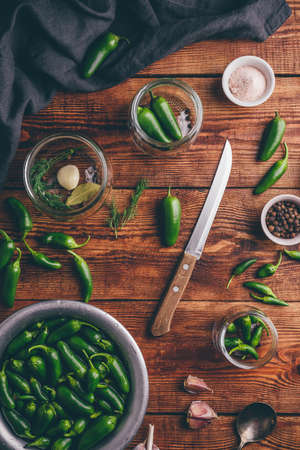 Jalapeno Peppers for Canning with Spices, Garlic and Glass Jars on Wooden Table. View from Aboveの写真素材