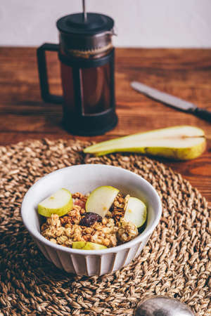 Bowl of Granola with Pear and Raisins for Breakfastの写真素材