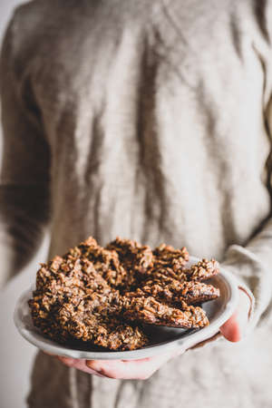 Man hold plate with banana oatmeal cookies with chocolate spreadの写真素材