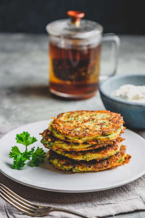 Zucchini parmesan pancakes with dip and parsley