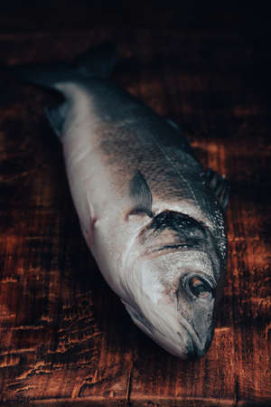 Fresh Sea Bass on Wooden Cutting Boardの素材 [FY310185477955]