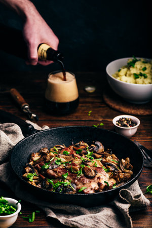 Fried pork neck steak with different mushrooms and mashed potatoesの写真素材
