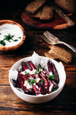 Oven baked beet fries with greek yogurt and dill dressingの写真素材