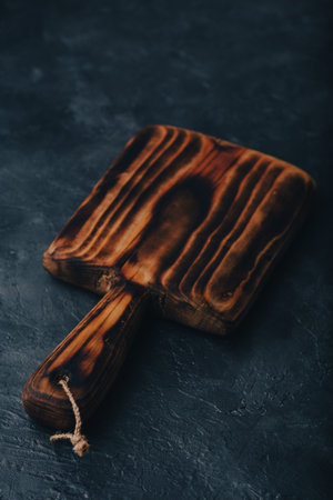 Small Handmade Cutting Board on Dark Concrete Backgroundの写真素材