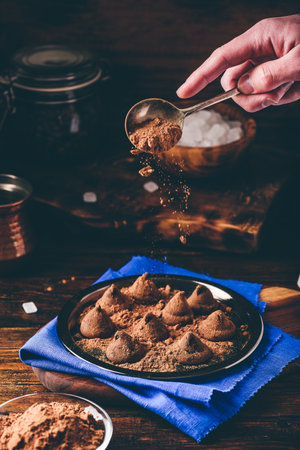 Homemade truffles with dark chocolate on metal trayの写真素材