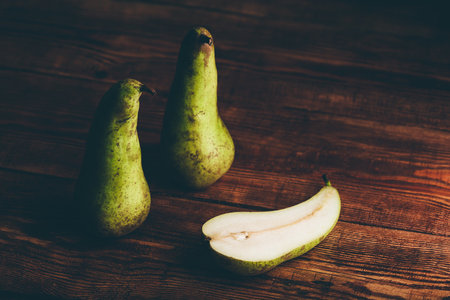 Still Life with Two Whole Conference Pears and One Halved.の写真素材